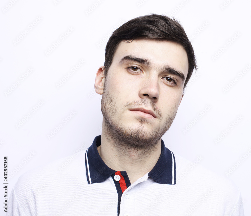 Portrait of young bearded sportsman looking into camera with disappointment and despair expression on his face.