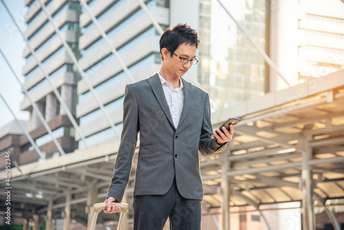 Business Man hands holding mobile phone outdoor surfing internet online technology lifestyle in city street. Entrepreneur young man in business suit hand using smartphone gadget text message lifestyle