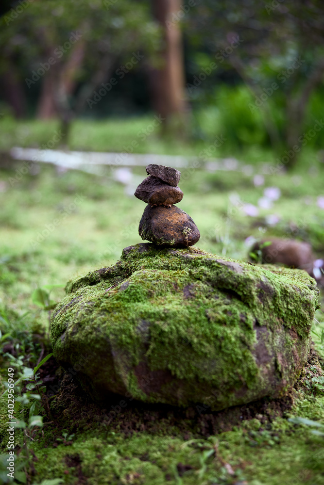 Stacked stones in front of green forest Stacked stones in front of green forest
