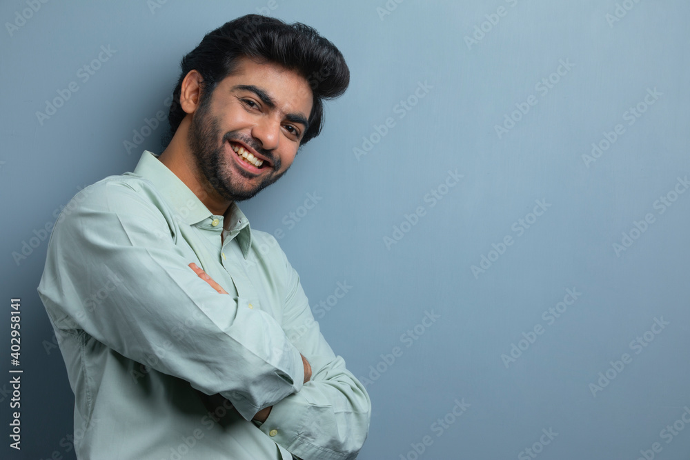 AN OFFICE EXECUTIVE HAPPILY STANDING AND SMILING AT CAMERA AN OFFICE EXECUTIVE HAPPILY STANDING AND SMILING AT CAMERA