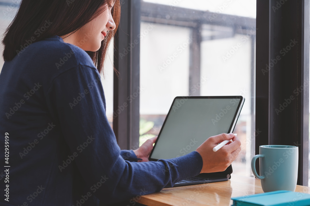 Beautiful asian woman using digital pen on tablet computer at modern office. Beautiful asian woman using digital pen on tablet computer at modern office.