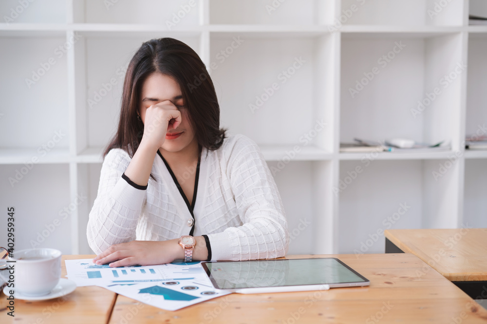 Tired frustrated young asian businesswoman feeling stressed holding head with hands, business problem failure concept Tired frustrated young asian businesswoman feeling stressed holding head with hands, business problem failure concept