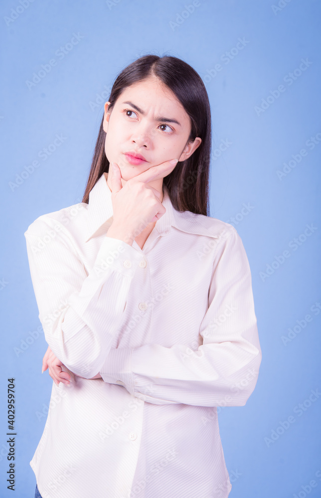 Businesswoman with a stern face on a blue background, studio portrait. Businesswoman with a stern face on a blue background, studio portrait.