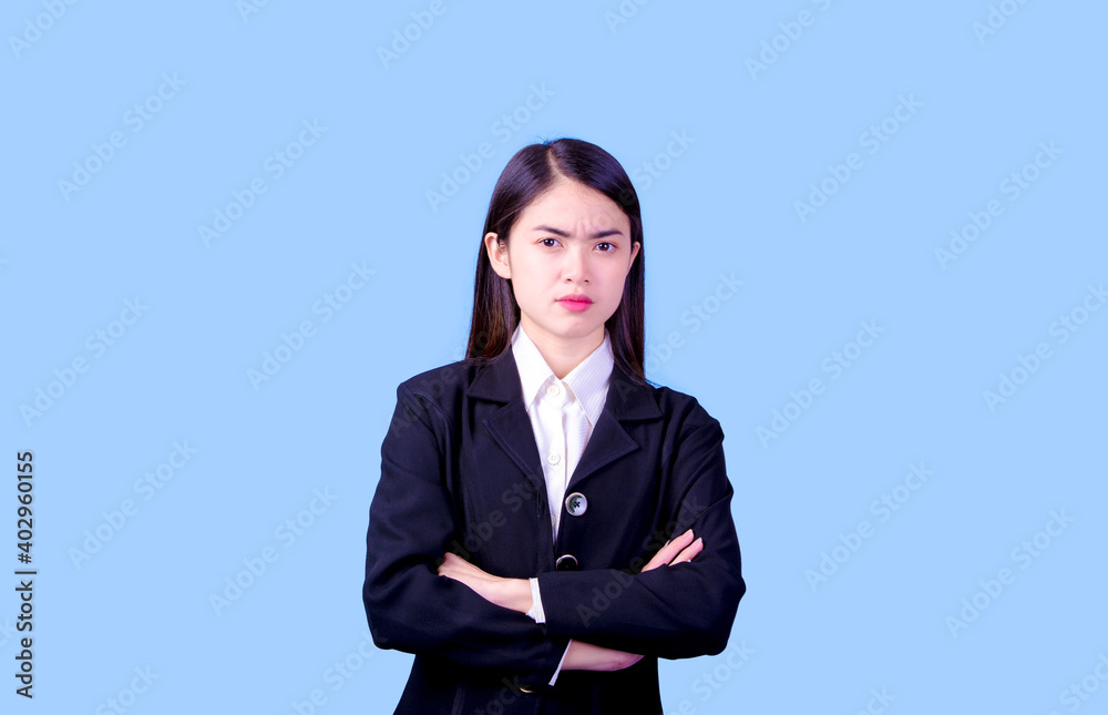 Businesswoman with a stern face on a blue background, studio portrait. Businesswoman with a stern face on a blue background, studio portrait.