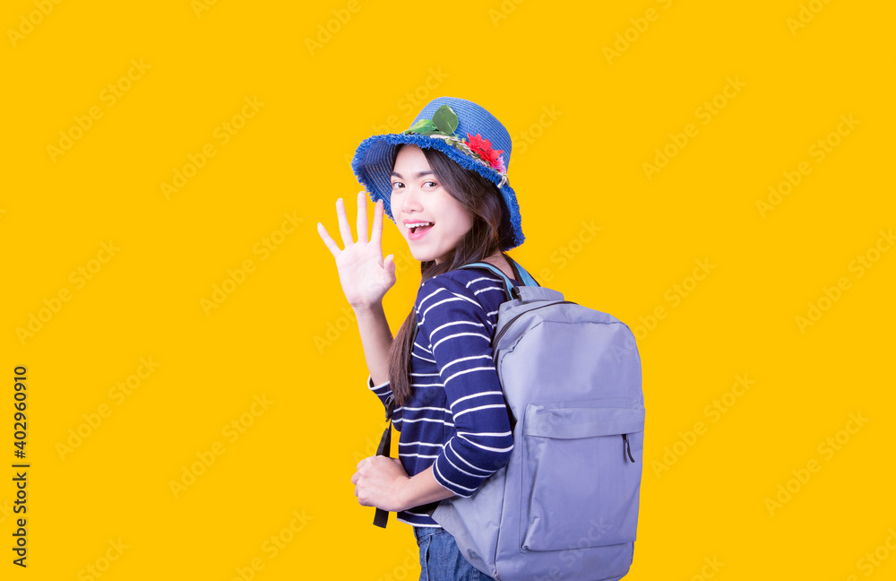 Asian woman tourist was running her to various places.happy excited emotional young woman photographer tourist standing isolated over Orange background Asian woman tourist was running her to various places.happy excited emotional young woman photographer tourist standing isolated over Orange background