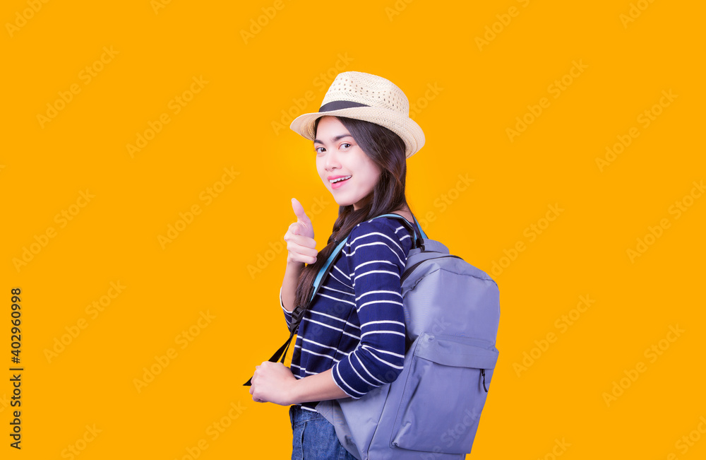 Asian woman tourist was running her to various places.happy excited emotional young woman photographer tourist standing isolated over Orange background