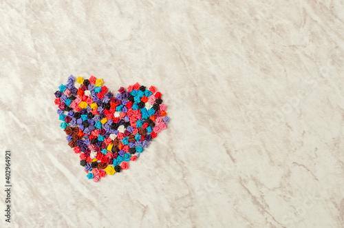 Heart of flowers on marble table.