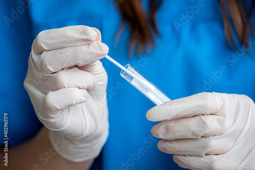 nurse holding nasal swab laboratory test for Coronavirus or COVID-19 photo
