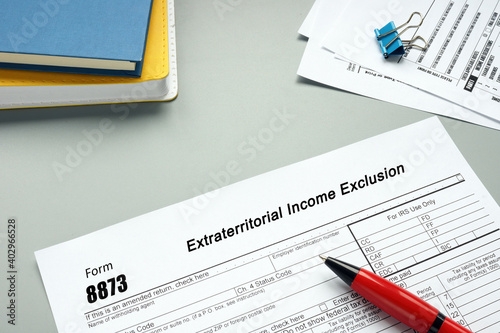 Business concept meaning Form 8873 Extraterritorial Income Exclusion with sign on the sheet.