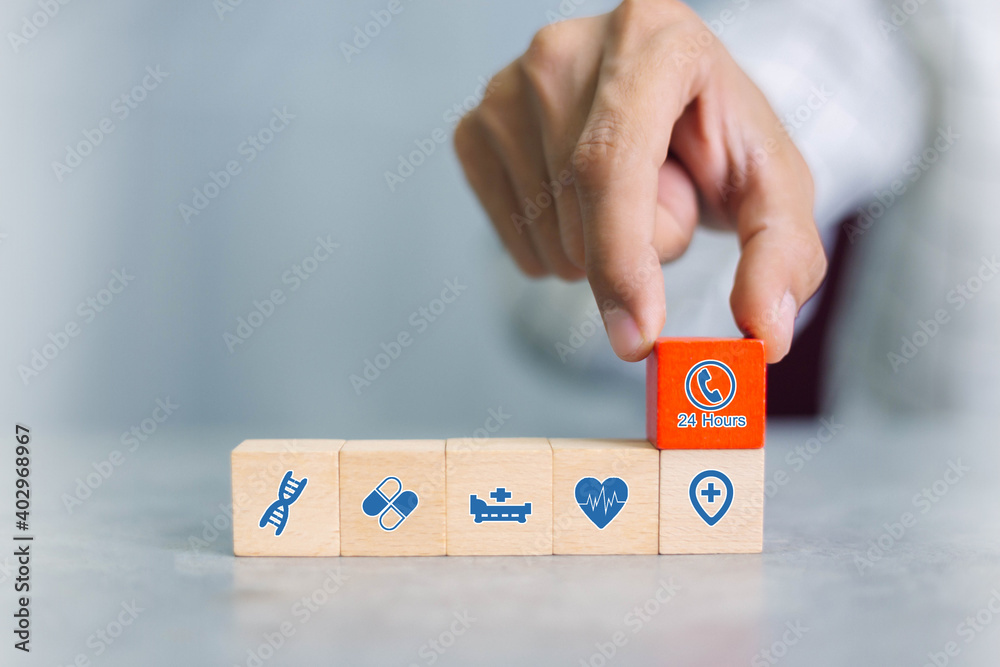 Hand arranging wood block with healthcare medical icon. Health insurance concept. Hand arranging wood block with healthcare medical icon. Health insurance concept.