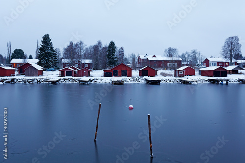 Obbola, Norrland Sweden - December 7, 2020: small boat storage and fishing cabins by the harbor photo