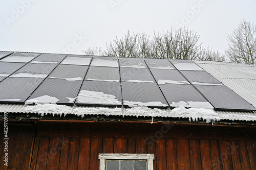 solar panels on roof a grey day with snow on them photo
