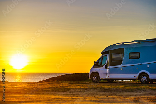 Camper car on beach at sunrise © Voyagerix