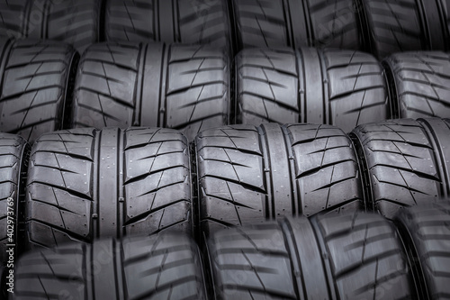 dark background of new sports tires with rain tread © Vladimir Razgulyaev