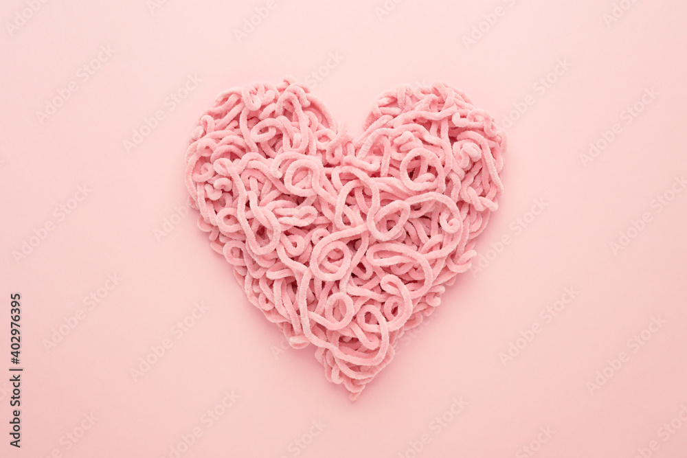 Valentines Day Heart made of yarn on pink background. Copy space, Flat lay. Compound love symbol. Valentines Day Heart made of yarn on pink background. Copy space, Flat lay. Compound love symbol.