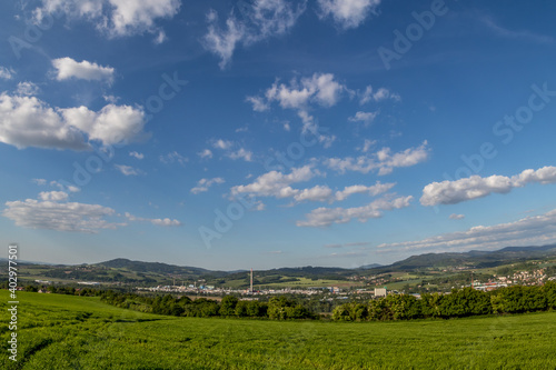 Views of the hills and surrounding city with views of the surrounding hills in the background of a blue sky with white clouds.