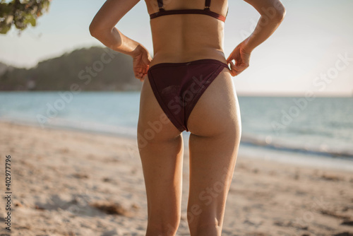 Beautiful woman in bikin standing on the beach. asian woman with sexy booty in bikini.