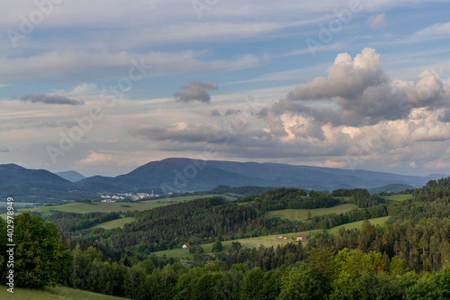 Fototapeta Naklejka Na Ścianę i Meble -  Landscape full of hills and mountains with clouds and blue sky with sun during colorful sunset Beskydy region.
