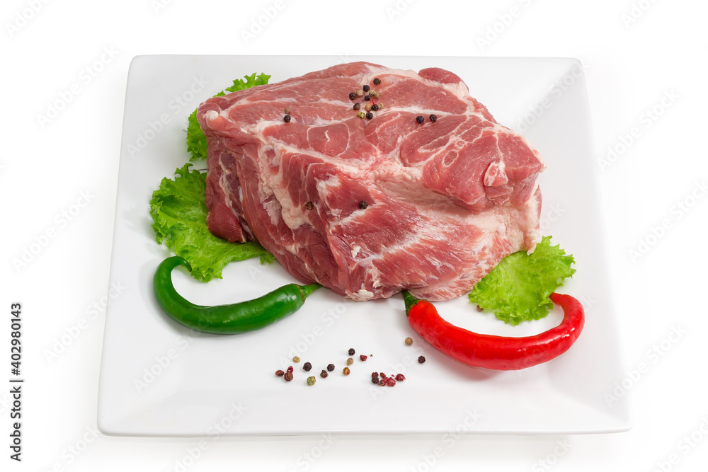 Piece of uncooked pork neck with spices on square dish Piece of uncooked pork neck with spices on square dish