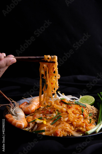 Pad Thai with shrimp in a black plate