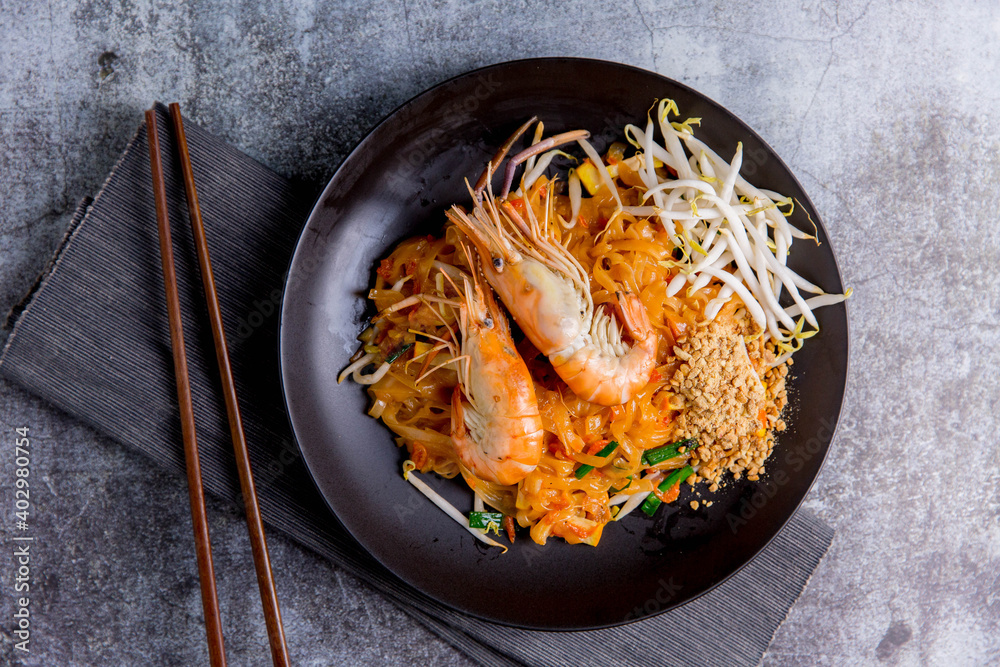 Udon Pad Thai with shrimp in a dark background, top view Asian style food Copy space Udon Pad Thai with shrimp in a dark background, top view Asian style food Copy space