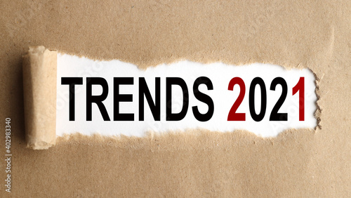 TRENDS 2021. text on white paper on torn paper background