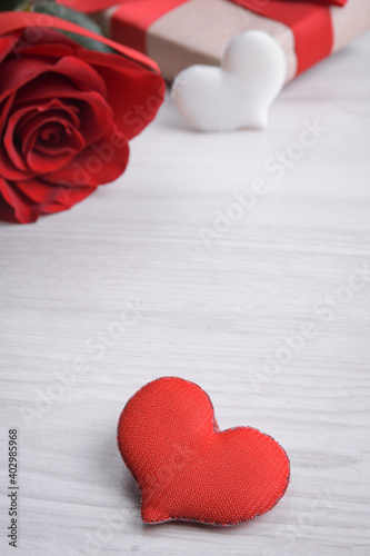 Background for Valentine's Day greeting card.Valentines day concept.Red gift ribbons, gifts, hearts on a wooden background.