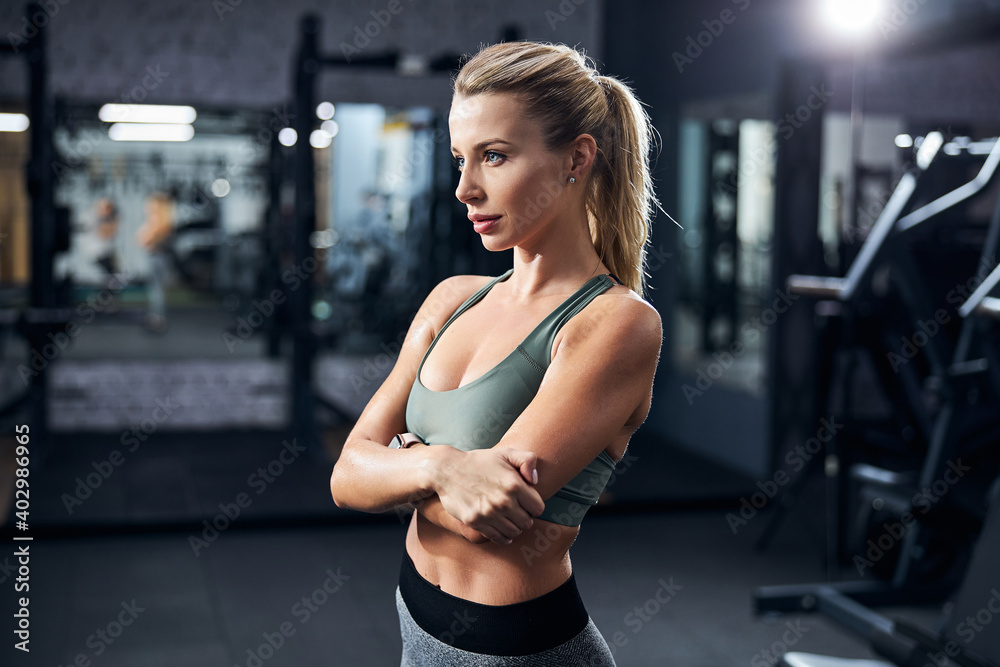 Beautiful woman hugging herself in an exercise room Beautiful woman hugging herself in an exercise room