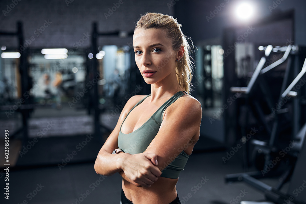 Fototapeta premium Interested sportswoman with arms across her chest