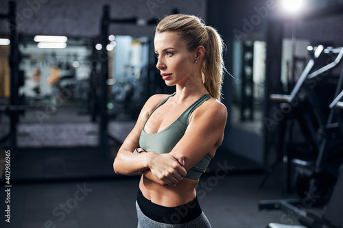 Beautiful woman hugging herself in an exercise room