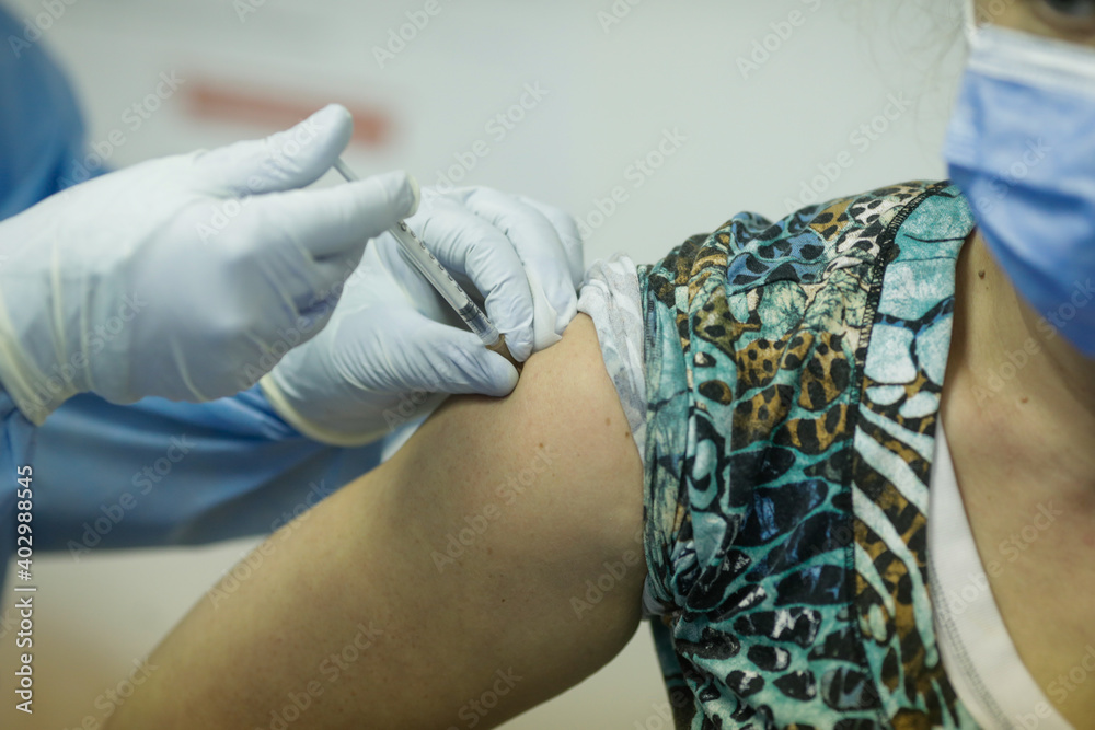 Fototapeta premium Shallow depth of field (selective focus) image with details of the Pfizer BioNTech vaccine in the hospital during the first day of vaccination.