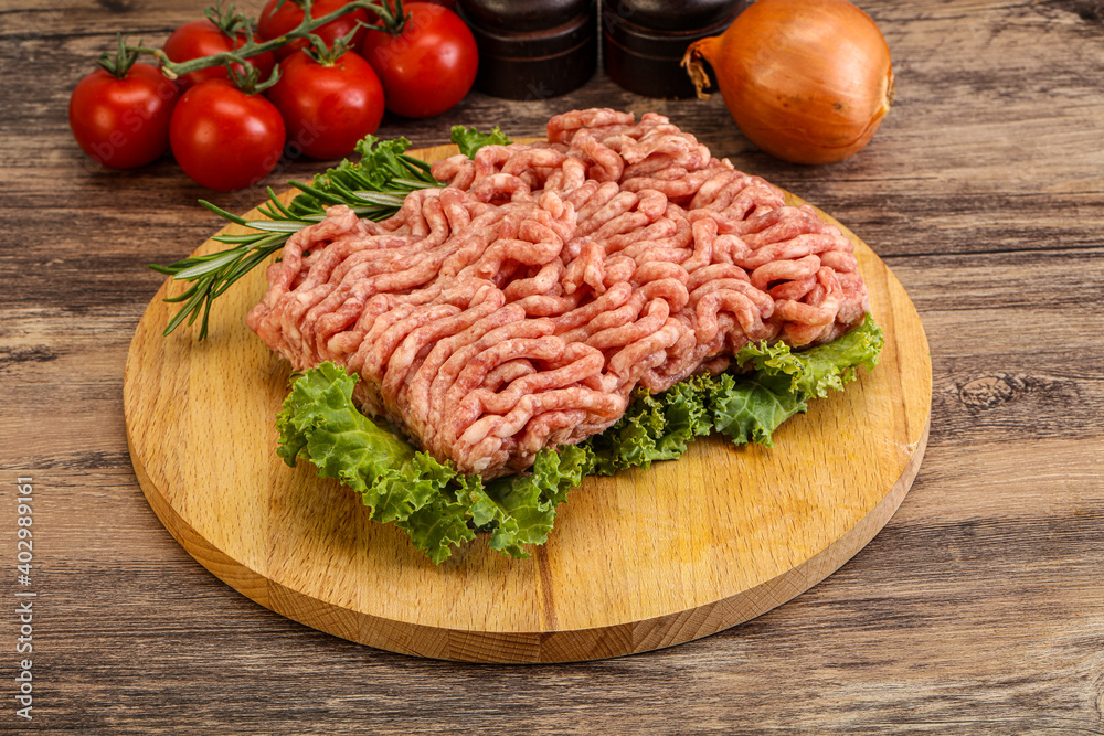 Raw pork minced meat over board Raw pork minced meat over board