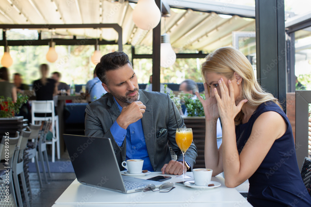 Worried business woman on a meeting in the restaurant, bad news concept Worried business woman on a meeting in the restaurant, bad news concept
