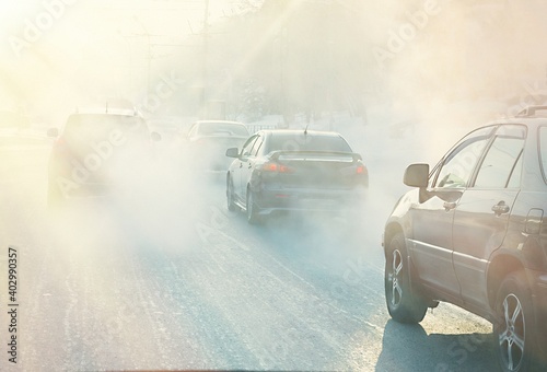 air pollution from exhaust fumes from cars in the city, on a cold day, air pollution in cities