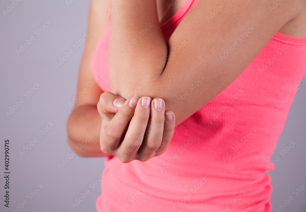Young woman suffering elbow pain.