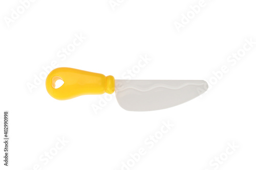 A plastic toy knife with a yellow handle. On a white background, isolated