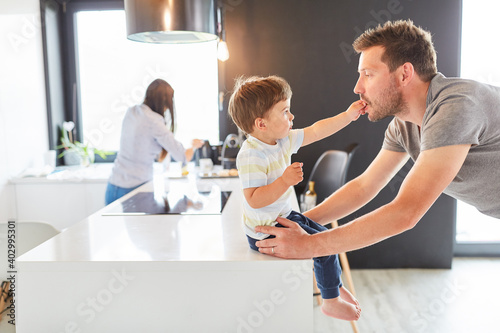 Vater spielt mit seinem Sohn in der Küche