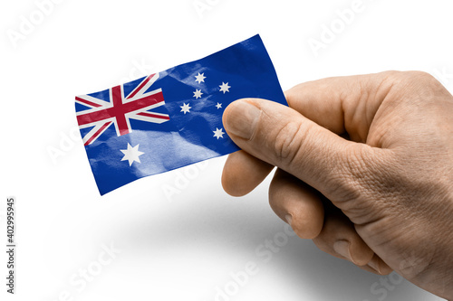 Hand holding a card with a national flag the Australia © butenkow