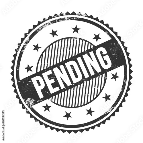 PENDING text written on black grungy round stamp. photo