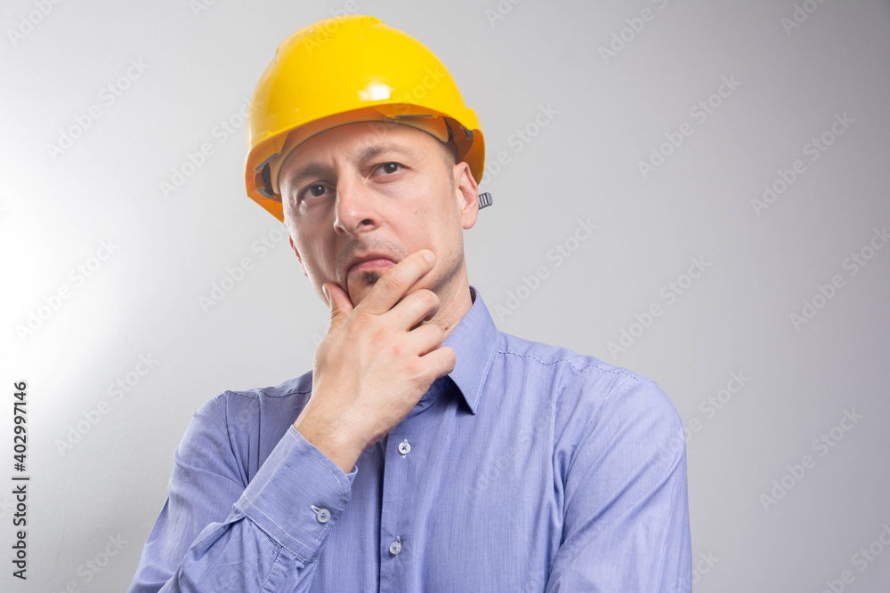 Construction engineer thinking with hand on chin: problem solving and planning concept. Construction engineer thinking with hand on chin: problem solving and planning concept.