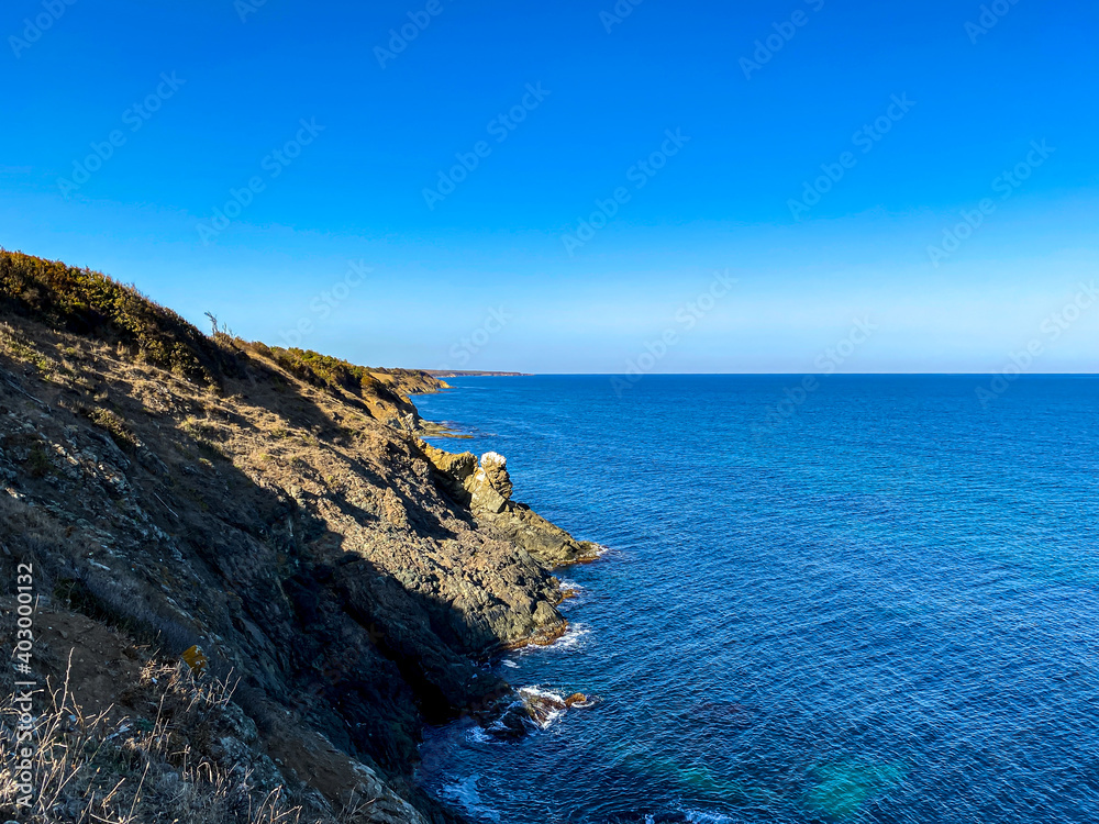 Blue sky and ocean rock coast 