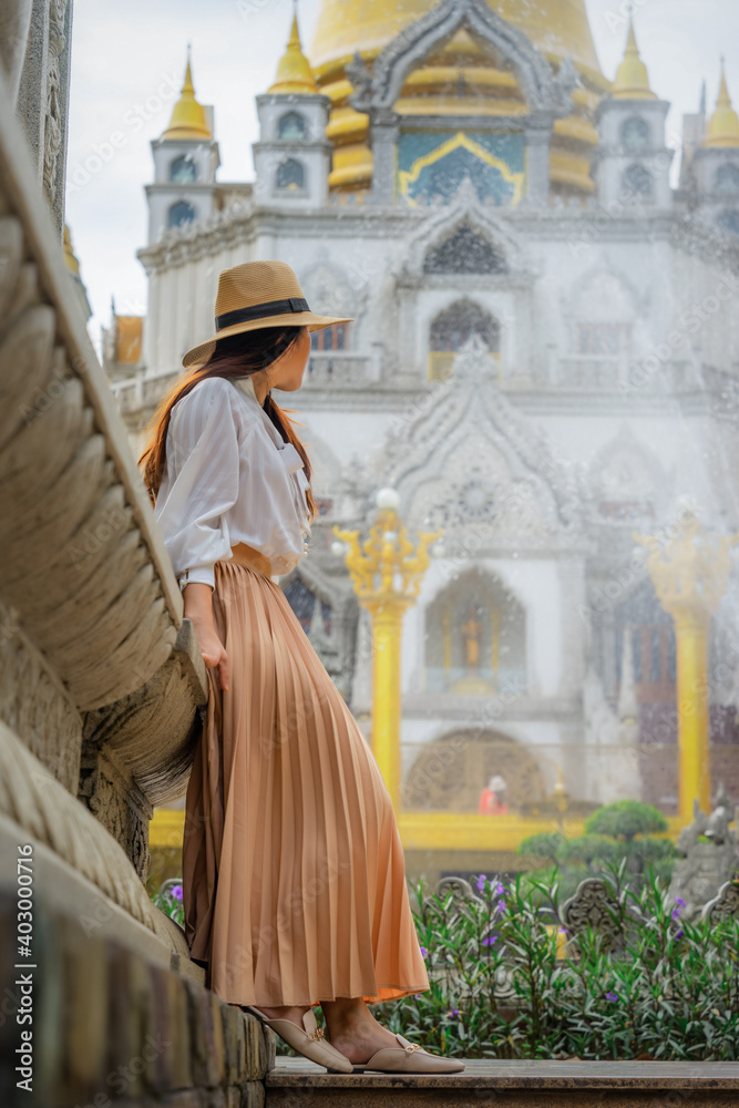 Happy asian woman walking outdoors in Buu Long Pagoda in Ho Chi Minh City. A beautiful buddhist temple hidden away in Ho Chi Minh City at Vietnam