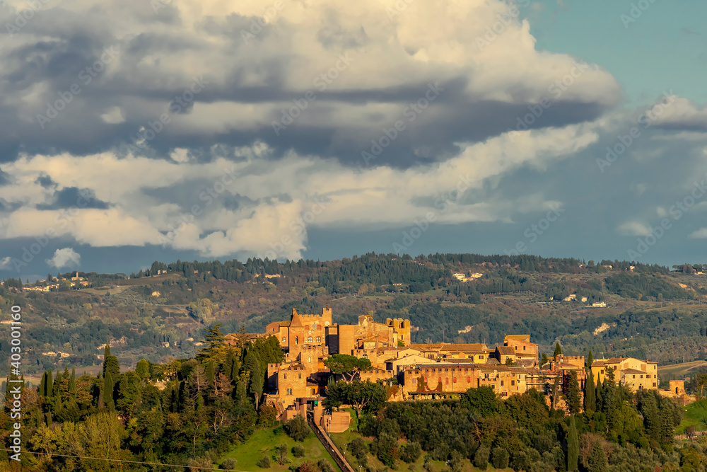 Panoramic view of Certaldo alto lit by the late afternoon sun, against a beautiful sky, Tuscany, Italy