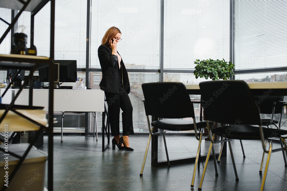 Portrait of smiling modern business woman in office Portrait of smiling modern business woman in office