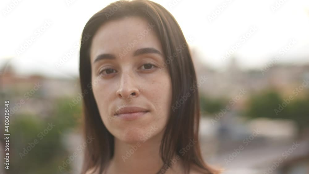 Close-up portrait of nice-looking white woman. Woman looking serious into camera. Female portraits.
