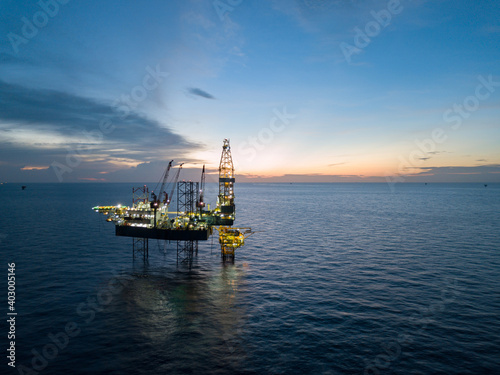 Aerial view offshore drilling rig (jack up rig) at the offshore location during sunset