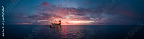 Leinwand Poster Aerial panorama view from a drone of an offshore jack up rig during sunset time