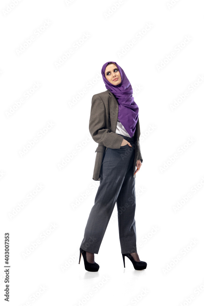Successful. Modern arab woman in stylish office attire isolated on studio background with copyspace for ad. Fashion, beauty, style concept. Female model with trendy make up, manicure and accessories. Successful. Modern arab woman in stylish office attire isolated on studio background with copyspace for ad. Fashion, beauty, style concept. Female model with trendy make up, manicure and accessories.