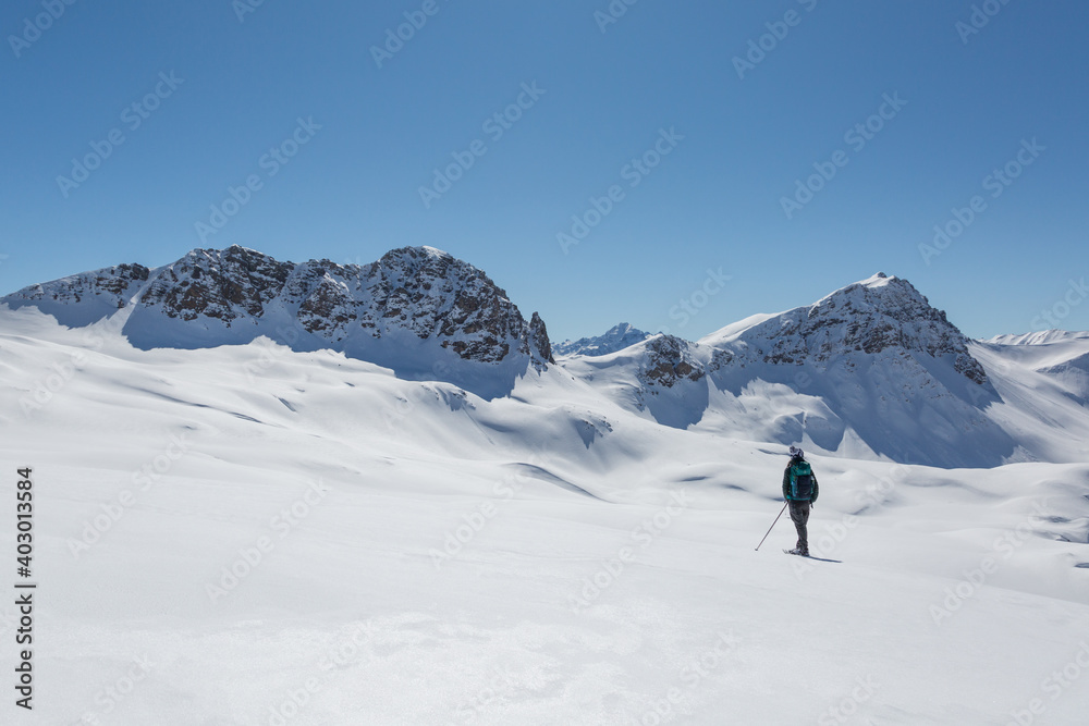 women with snowshoes standing in  snowy winter landscape in Schanfigg