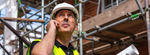 Male Builder Construction Worker on Building Site Using Phone Web Banner